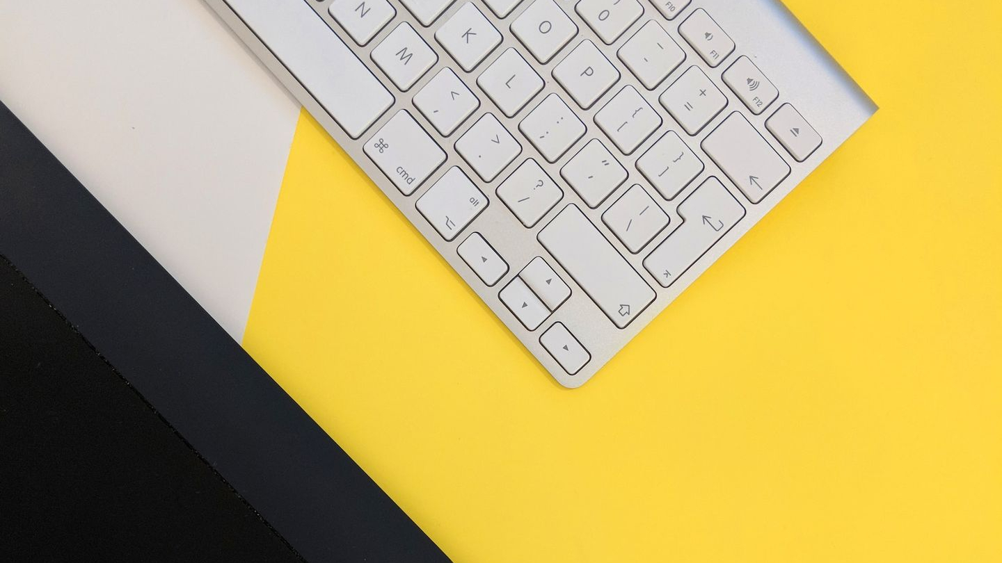 gray Apple wireless keyboard beside black tablet computer and stylus pen